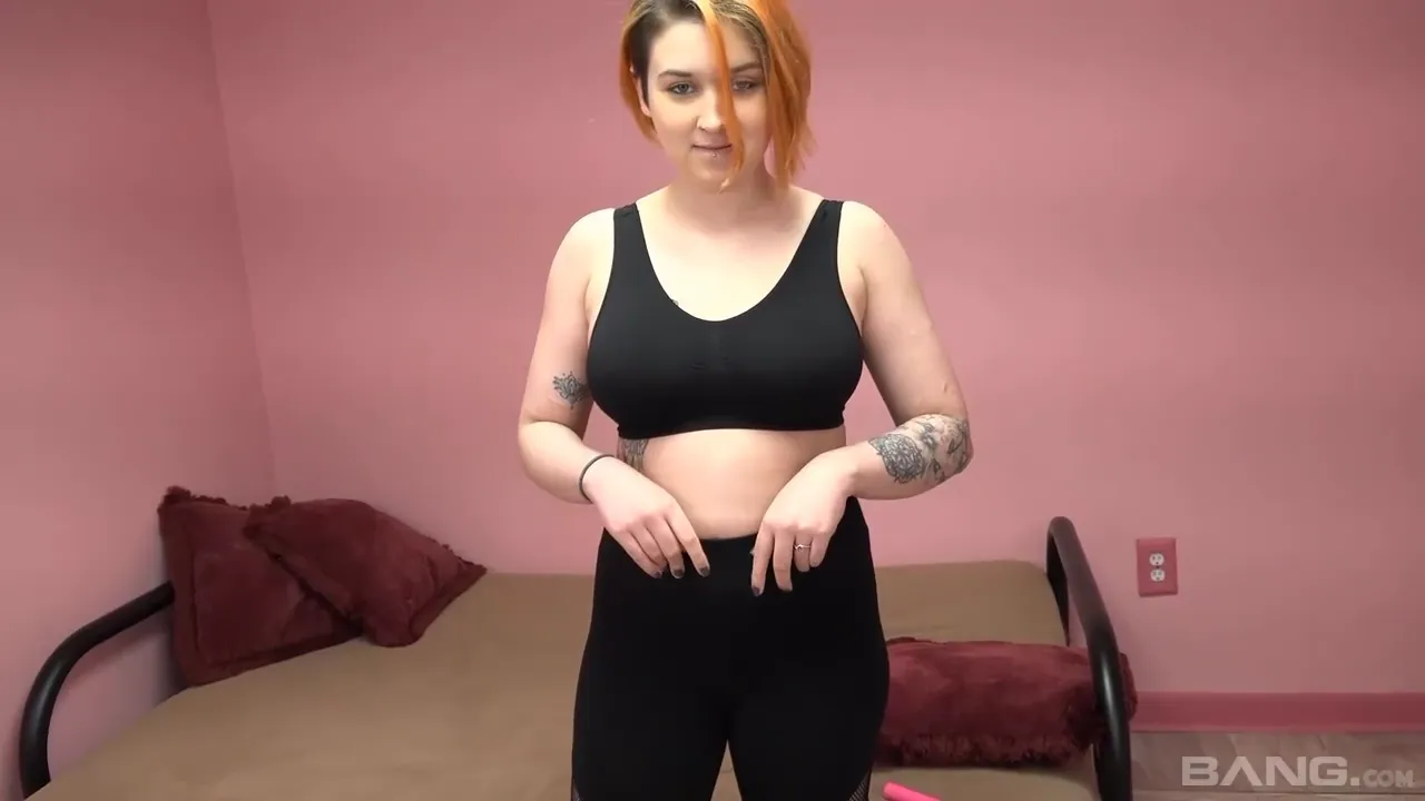 Redhead in Torn Leggings Awaits Passionate Encounter