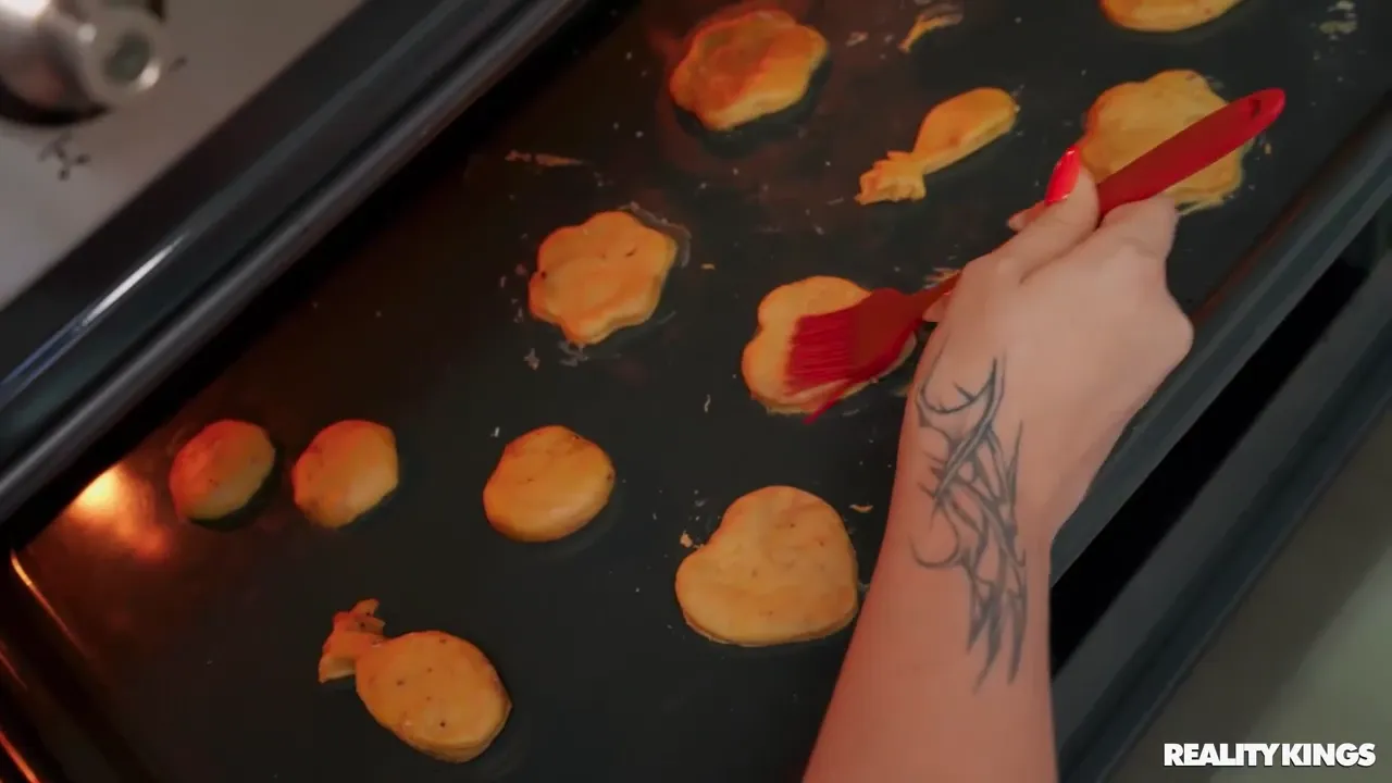 Seductive Redhead Maid Delights Young Man in the Kitchen