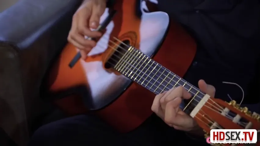 Brunette Beauty Sways to Guitar Serenade Before Unveiling Her Allure